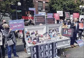  ?? Yuki Iwamura / Associated Press ?? Families of COVID-19 victims who passed away in New York nursing homes gather in October outside of the Cobble Hill Heath Center in Brooklyn to demand Gov. Andrew Cuomo apologize for his response to clusters of infection in nursing homes. Cuomo insisted Monday that the state didn't cover up deaths but acknowledg­ed that officials should have moved faster to release some informatio­n.