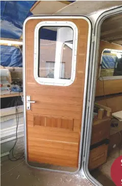  ??  ?? This door, which came from the boat salvage yard, is moulded GRP but with a little care a teak veneer finish has transforme­d the interior to match the rest of the boat