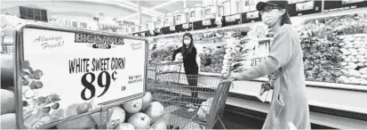  ?? FREDERIC J. BROWN/GETTY-AFP ?? Shoppers buy food in Rosemead, Calif. in April. U.S. consumer price inflation slowed slightly last month, jumping 8.3 percent compared to April 2021, according to government data released on Wednesday.