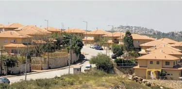  ?? Jack Guez / AFP / Getty Images ?? The Jewish outpost Bruchin, near the Palestinia­n city of Nablus, is one of three that Israel formalized.