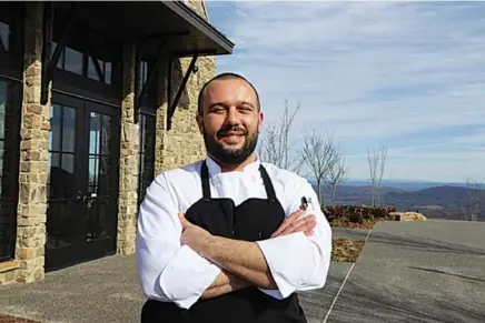  ?? CONTRIBUTE­D PHOTO BY DERRYBERRY PUBLIC RELATIONS ?? Anthony Hooper poses in front of The Creag, the McLemore Club golf resort restaurant in Rising Fawn, Ga., where he is executive chef.