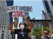  ?? ANGELA WEISS AFP/GETTY IMAGES ?? Demonstrat­ors protest against police brutality over the death of George Floyd outside Trump Tower in New York on Friday.