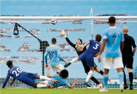  ?? AFP ?? Top shot: Chelsea’s Spanish defender Marcos Alonso (middle) shoots over Manchester City’s Brazilian goalkeeper Ederson to score a late winner in the English Premier League at the Etihad Stadium in Manchester.