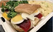  ??  ?? Salt Block Biscuit Company Caster and Whaler biscuit sandwich topped with smoked trout, hard-boiled egg, pickled beets and onion, herb aioli and parsley.