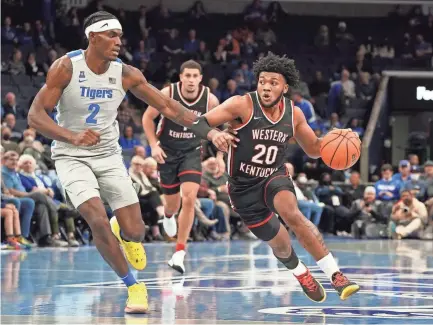  ?? KAREN PULFER FOCHT/AP ?? Memphis’ Jalen Duren (2) defends against Western Kentucky’s Dayvion Mcknight (20) the first half Friday in Memphis.