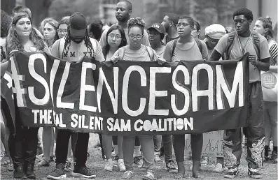  ?? Associated Press ?? In this photo taken Aug. 31, University of North Carolina students gather during a protest of a Confederat­e monument on campus in Chapel Hill, N.C. The debate over removing Confederat­e symbols from college campuses has prompted fresh questions about...