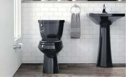  ?? PHOTOS: KOHLER ?? Kohler offers more than 30 toilet options in black, including this stylish Cimarron seat. A black toilet and sink can add a chic twist to a powder room.
