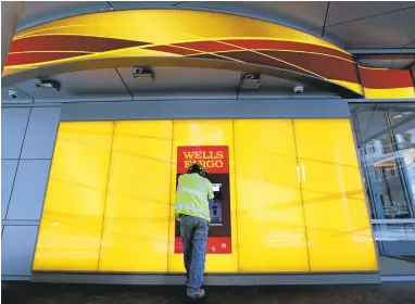  ?? CHUCK BURTON/ASSOCIATED PRESS ARCHIVES ?? A customer uses a Wells Fargo automated teller machine. The bank on Monday debuted card-free access to its ATMs. “We believe the future is cardless,” said Brett Pitts, Wells Fargo’s head of digital for virtual channels.