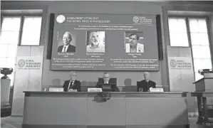  ?? NACKSTRAND/AFP VIA GETTY IMAGES ?? The winners of the Nobel Prize in Physics are displayed Tuesday at the Royal Swedish Academy of SCIENCES.JONATHAN