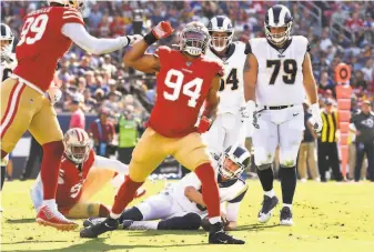  ?? Wally Skalij / Los Angeles Times ?? Niners defensive lineman Solomon Thomas (94) celebrates his sack of Rams quarterbac­k Jared Goff. Although it was his second of the season, Thomas considered it his first “real” sack.