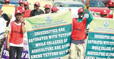  ??  ?? Members of the Academic Staff Union of Research Institutio­ns (ASURI), protesting against lack of funds to conduct research projects, in Abuja…yesterday PHOTO: LUCY LADIDI ELUKPO