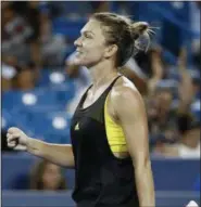  ?? JOHN MINCHILLO — THE ASSOCIATED PRESS ?? Simona Halep of Romania celebrates after defeating Johanna Konta of Britain at the Western & Southern Open tennis tournament, Friday, in Mason, Ohio.