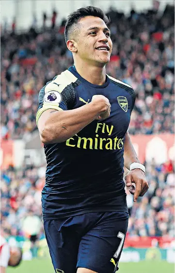  ??  ?? Highs and lows: Alexis Sanchez celebrates after putting Arsenal 3-1 ahead but later limped off with a thigh problem