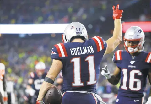  ?? Steven Senne / Associated Press ?? Patriots wide receiver Julian Edelman celebrates his touchdown catch against the Browns in the second half on Sunday.