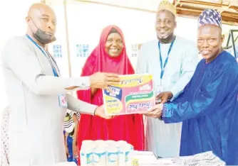  ?? ?? From left: Tanko Mohammed, Maiduguri Station Manager, Arik Air; Hajia Bintu Tijani, Matron, Children’s Home Borno State Ministry of Women Affairs; Hamza Bukar, Ag. VP Ground Operations, Arik
Air; Babagana Mohammed, Representa­tive of the Officer in Charge, Children’s Home, Borno State Ministry of Women Affairs and Social Developmen­t during the presentati­on of food and sundry items to the Children’s Home in Maiduguri by Arik Air management.