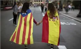  ?? ASSOCIATED PRESS FILE PHOTO ?? Girls wear Spanish and independen­ce flags as they take part in a demonstrat­ion in Barcelona, Spain, in October. Regional elections take place Thursday.