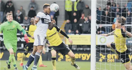  ??  ?? Britt Assombalon­ga scores Middlesbro­ugh’s late equaliser at Burton.