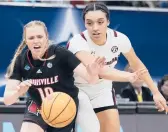  ?? CHARLIE NEIBERGALL/AP ?? South Carolina’s Brea Beal, right, and Louisville’s Hailey Van Lith go after a loose ball in the second half of Friday’s Final Four matchup in Minneapoli­s.