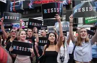  ?? The Associated Press ?? Protesters gather Wednesday in New York City’s Times Square during a rally against President Donald Trump’s announceme­nt of a proposed ban on transgende­r troops serving anywhere in the U.S. military.