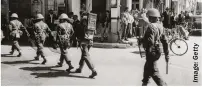  ??  ?? British soldiers, equipped with riot gear, patrol the streets of Nicosia during the Emergency