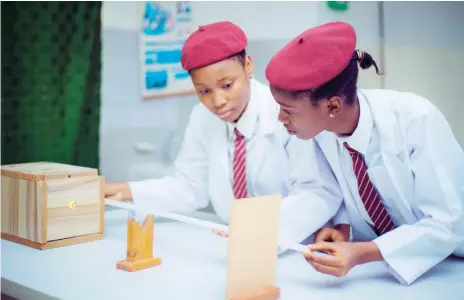  ??  ?? Students perform science experiment at El-Amin Internatio­nal School, Minna