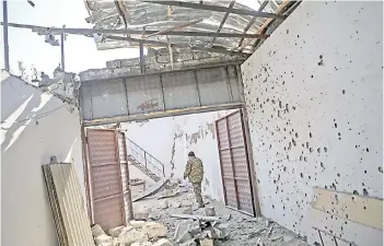  ?? — AFP photo ?? The mayor of Martakert Misha Gyurjian inspects the grounds of a building destroyed by shelling in Martakert, during the ongoing fighting between Armenia and Azerbaijan over the disputed region of Nagorno-Karabakh.