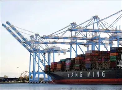  ?? (AP file photo) ?? Cargo cranes unload a Yang Ming Marine Transport Corp. ship in November at the Port of Tacoma in Tacoma, Wash. The U.S. trade deficit narrowed in February.