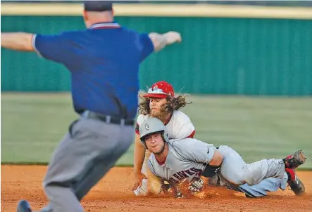  ?? STAFF PHOTO BY DOUG STRICKLAND ?? Stewarts Creek runner Jake Alexander is called safe as he slides into Ooltewah second baseman Jake Morrow during their Class AAA sectional baseball game Friday night at Ooltewah. The visiting Red Hawks won in 10 innings.