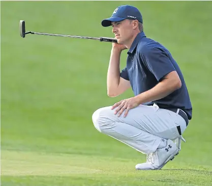  ??  ?? Jordan Spieth lines up his birdie putt on the 17th green during the first round at Augusta National.