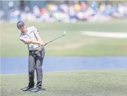  ??  ?? Mackenzie Hughes hits from the sixth fairway during the first round of The Players Championsh­ip at TPC Sawgrass.