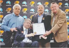  ?? ARLEN REDEKOP/ FILES ?? B.C. Lions business VP George Chayka, second from right, remembers late owner David Braley, right, as a man with a great passion for the task of financing and operating the CFL team.