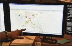  ?? AP PHOTO/LISA MARIE PANE ?? In this March 15 file photo, a supervisor shows one of the maps used by dispatcher­s at a 911 call center in Roswell, Ga. Apple is trying drag the U.S.’s antiquated system for handling 911 calls into the 21st century.