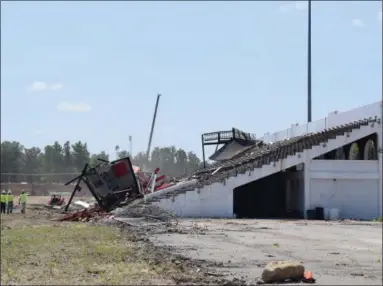  ?? BRIANA CONTRERAS — THE MORNING JOURNAL ?? The demolition of a 91-year-old grandstand at the original Ely Stadium in Elyria began July 11, with the press box to take the first tumble down. This demolition makes room for a next phase of the new Elyria City Schools multi-sports complex.