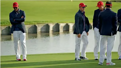  ?? AP ?? Tiger Woods (left) is left a forlorn man during the closing ceremony after the US lost to Europe in the Ryder Cup. —