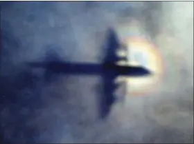  ??  ?? In this March 31, 2014, file photo, the shadow of a Royal New Zealand Air Force P3 Orion is seen on low level cloud while the aircraft searches for missing Malaysia Airlines Flight MH370 in the southern Indian Ocean, near the coast of Western...