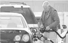  ?? JUSTIN SULLIVAN, GETTY IMAGES ?? A man fills up in March in Mill Valley, Calif. After a blockbuste­r driving season, gas prices may dip.