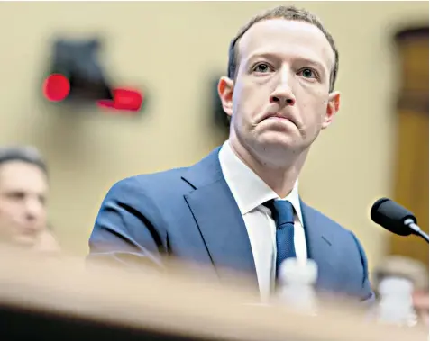  ??  ?? Mark Zuckerberg swapped his usual T-shirt for a smart suit and his notes revealed that he had been coached extensivel­y for his two-day interrogat­ion by members of Congress