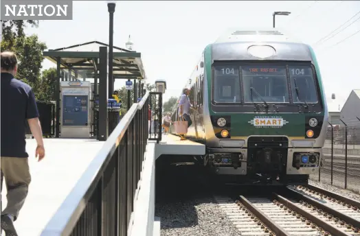  ?? Erik Castro / Special to The Chronicle ?? Passengers board a SMART train in Santa Rosa on the first day of service in August. Eventually, the commuter rail line will extend to the ferry to San Francisco. Santa Rosa is also preparing for taller buildings and a larger airport.