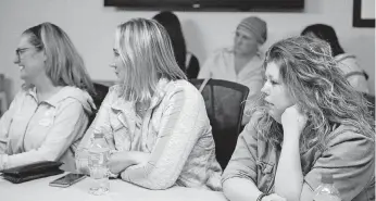  ??  ?? Jennifer Harrod, left, Kelly Norton and Michelle Tramutolo listen to a presentati­on on managing pain.