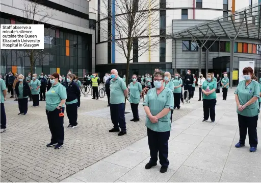  ??  ?? Staff observe a minute’s silence outside the Queen Elizabeth University Hospital in Glasgow