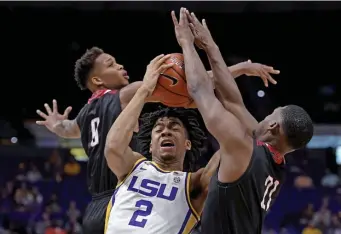  ?? AP ?? LOOK OUT BELOW: LSU forward Trendon Watford (2) drives the to the basket through heavy traffic from Nicholls defenders guards D'Angelo Hunter, left, and Brandon Moore Jr. in the first half yesterday.