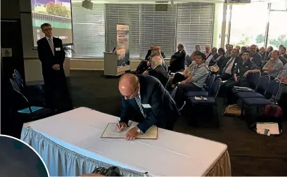  ?? AMBER-LEIGH WOOLF/ STUFF ?? Niwa CEO John Morgan signs the global Unified Model, one of the world’s foremost weather and climate forecastin­g collaborat­ions.