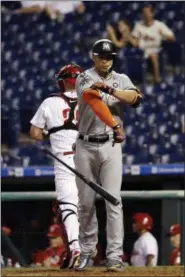  ?? MATT SLOCUM — THE ASSOCIATED PRESS ?? Miami Marlins’ Giancarlo Stanton throws his bat after striking out against Philadelph­ia Phillies relief pitcher Luis Garcia during the 13th inning of a baseball game, Sept. 12 in Philadelph­ia. Philadelph­ia won 9-8 in 15 innings.