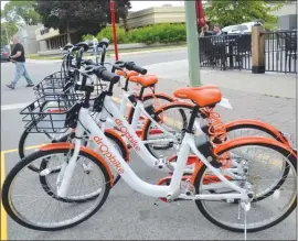  ?? RON SEYMOUR/The Daily Courier ?? Dropbikes are now available for rent at many locations in downtown Kelowna, including this spot at the corner of St. Paul Street and Doyle Avenue.