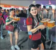  ?? AP ?? Fans carry their beer at a fan zone ahead of the FIFA World Cup in Doha, Qatar on Saturday.