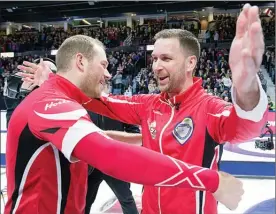  ?? The Canadian Press ?? Team Canada skip Brad Gushue, right, celebrates with Geoff Walker after defeating Alberta 6-4 to win the Tim Hortons Brier at the Brandt Centre in Regina on Sunday.