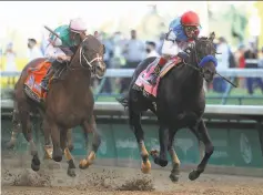  ?? Rob Carr / Getty Images ?? Medina Spirit (right), with jockey John Velazquez up, edges Mandaloun and jockey Florent Geroux at Churchill Downs.