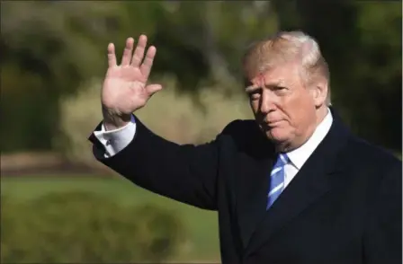  ?? SUSAN WALSH — THE ASSOCIATED PRESS ?? President Donald Trump waves as walks from Marine One on the South Lawn of the White House in Washington, Thursday after returning from a trip to West Virginia.