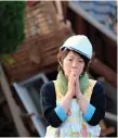  ??  ?? A woman in front of damaged house in Mashiki, Japan after an earthquake in 2016