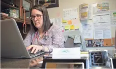  ??  ?? Family physician Joanna Bailey, at her desk at Tug River Catterson Health Center in Pineville, W.Va., says about 30% of her cases are seeking treatment for mental illness.